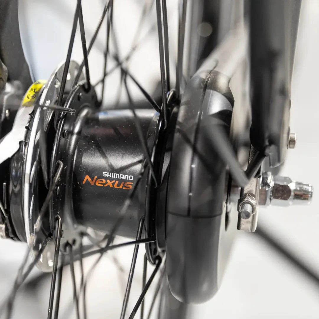 A close-up of the wheel hub on the Cortina Common Family electric bike