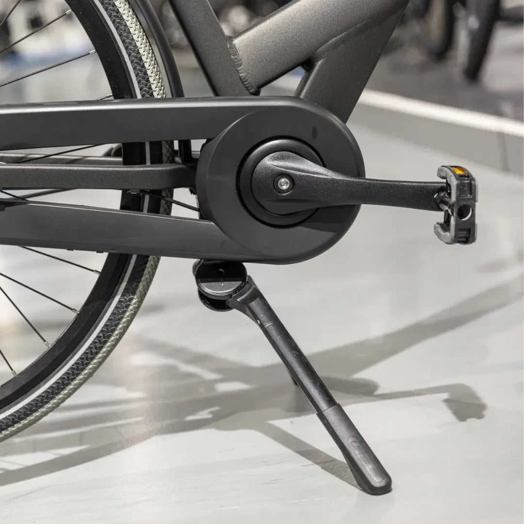 A close-up of the pedal and stand of the Cortina Common Family electric bike on display
