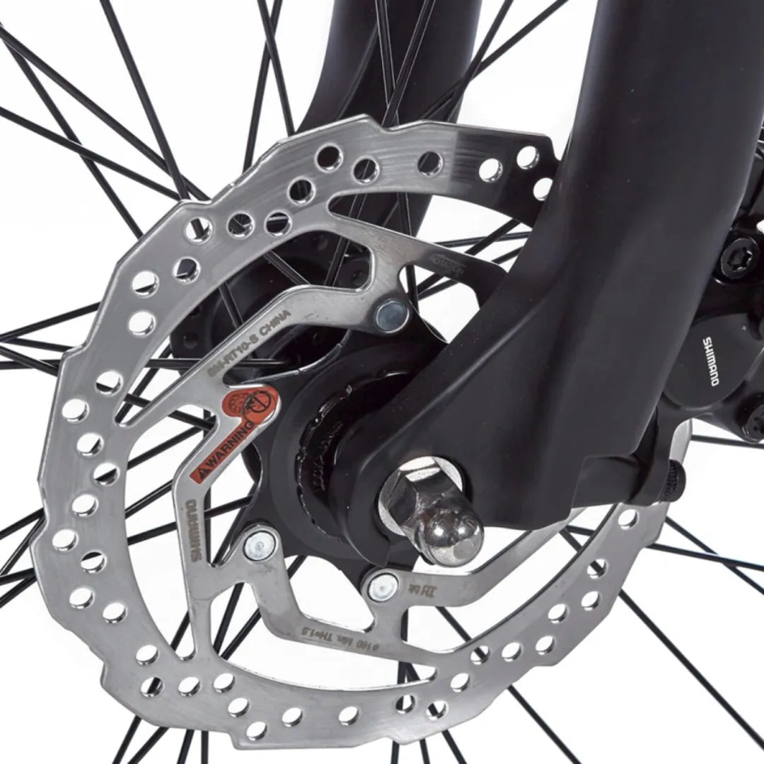 A close-up of the disc brakes on the Cortina E Mozzo electric bike, showing its detailed design