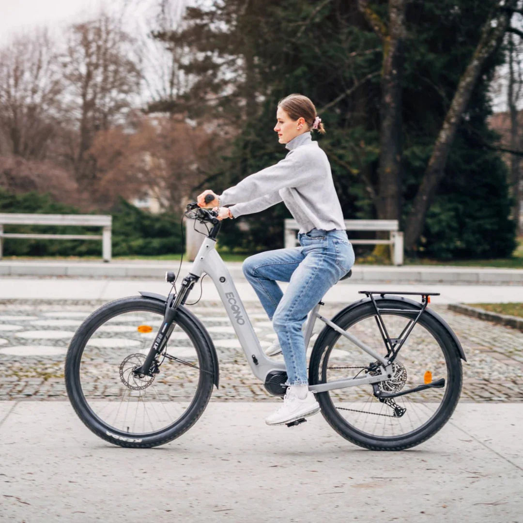 Electric Bike Econo Gams Suv Eec6, stylish electric bike in gray, woman riding in casual outfit outdoors.