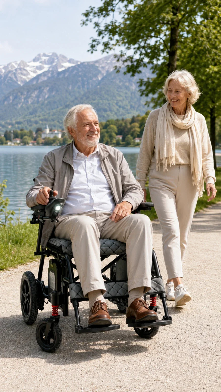Electric wheelchair ComfyGO X7 – man in chair with woman walking beside him along a lakeside path
