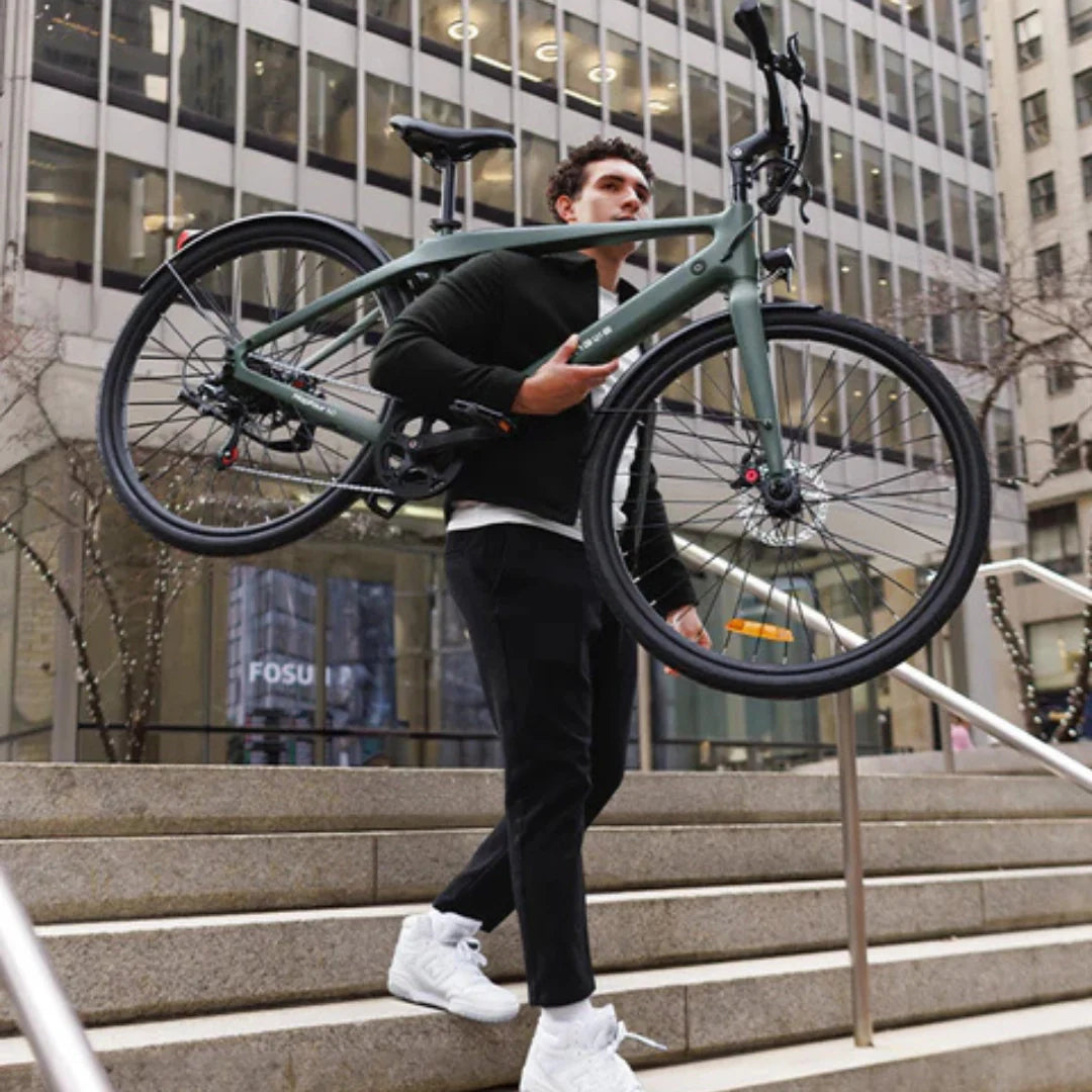 Electric bicycle Engwe MapFour N1 AIR – man carrying bike up stairs