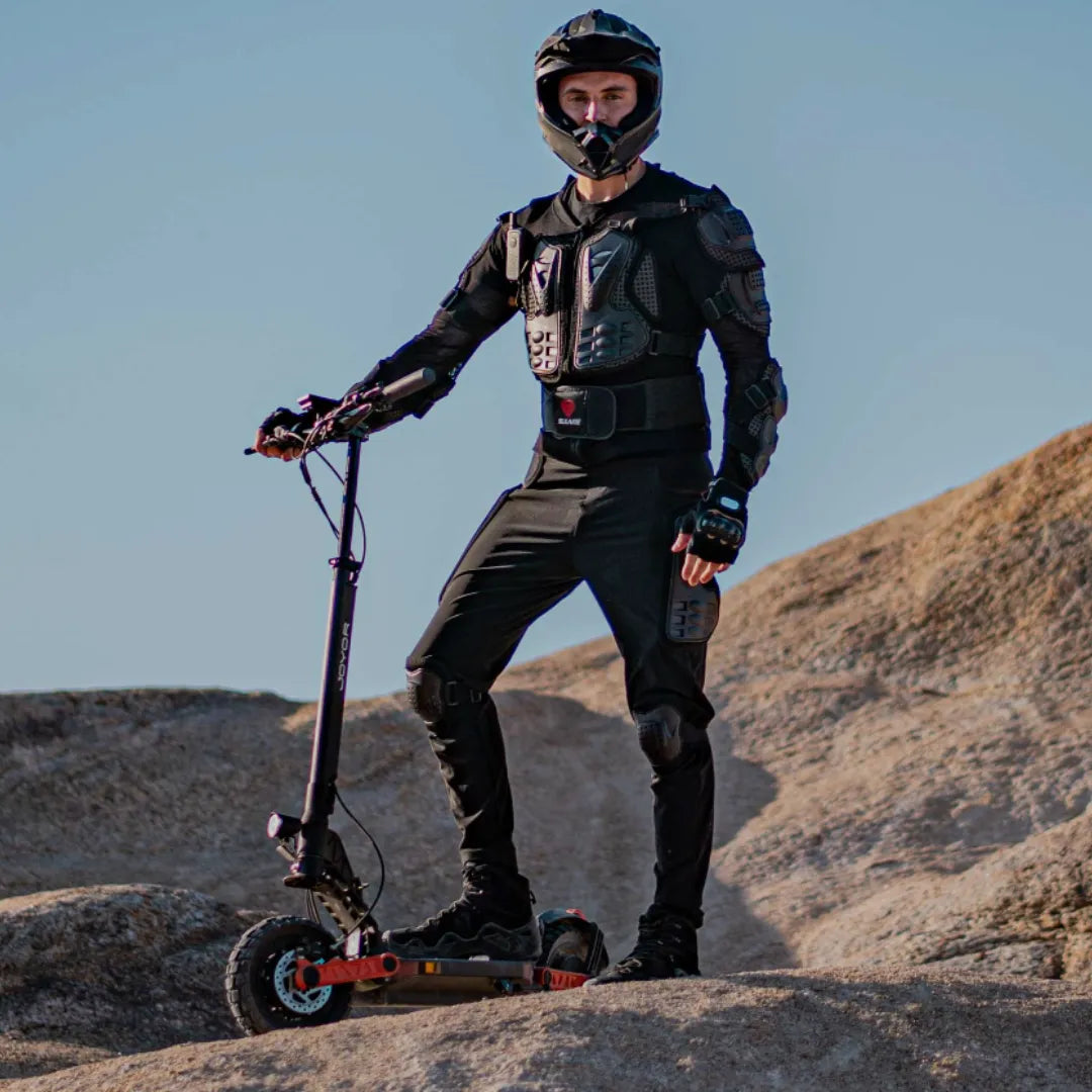 Electric scooter Joyor S10-S-Z – man in protective gear on rocky terrain