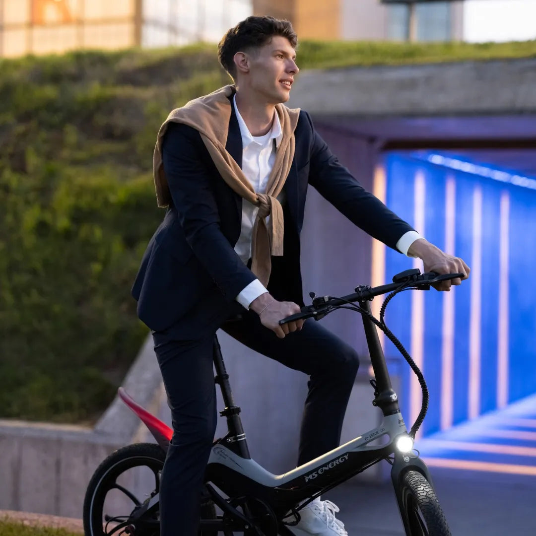 Electric Bike Ms Energy I20 features a sleek design, ideal for urban commuting, stylishly ridden by a man in a suit.