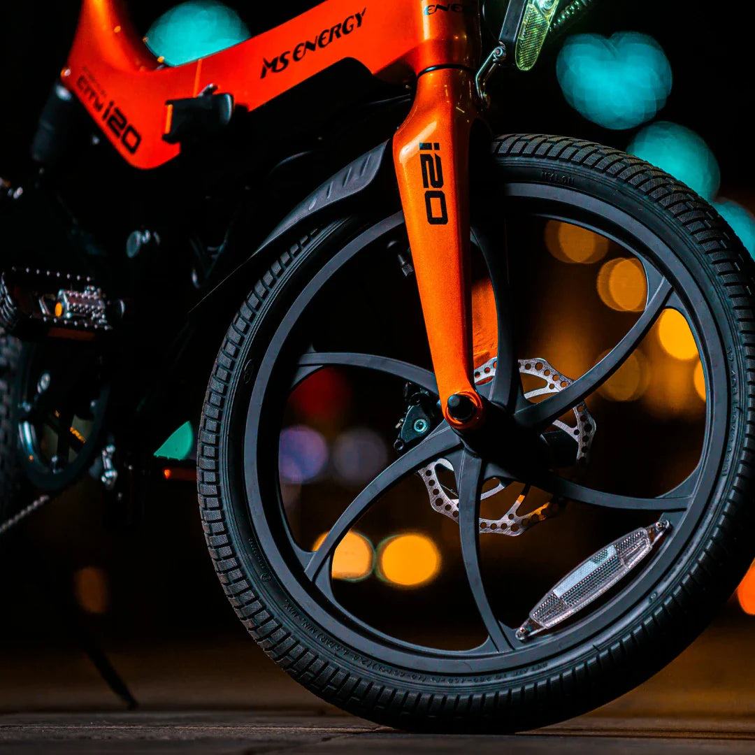 Electric Bike Ms Energy I20 features a vibrant orange frame, stylish wheel design, and advanced disc brake.