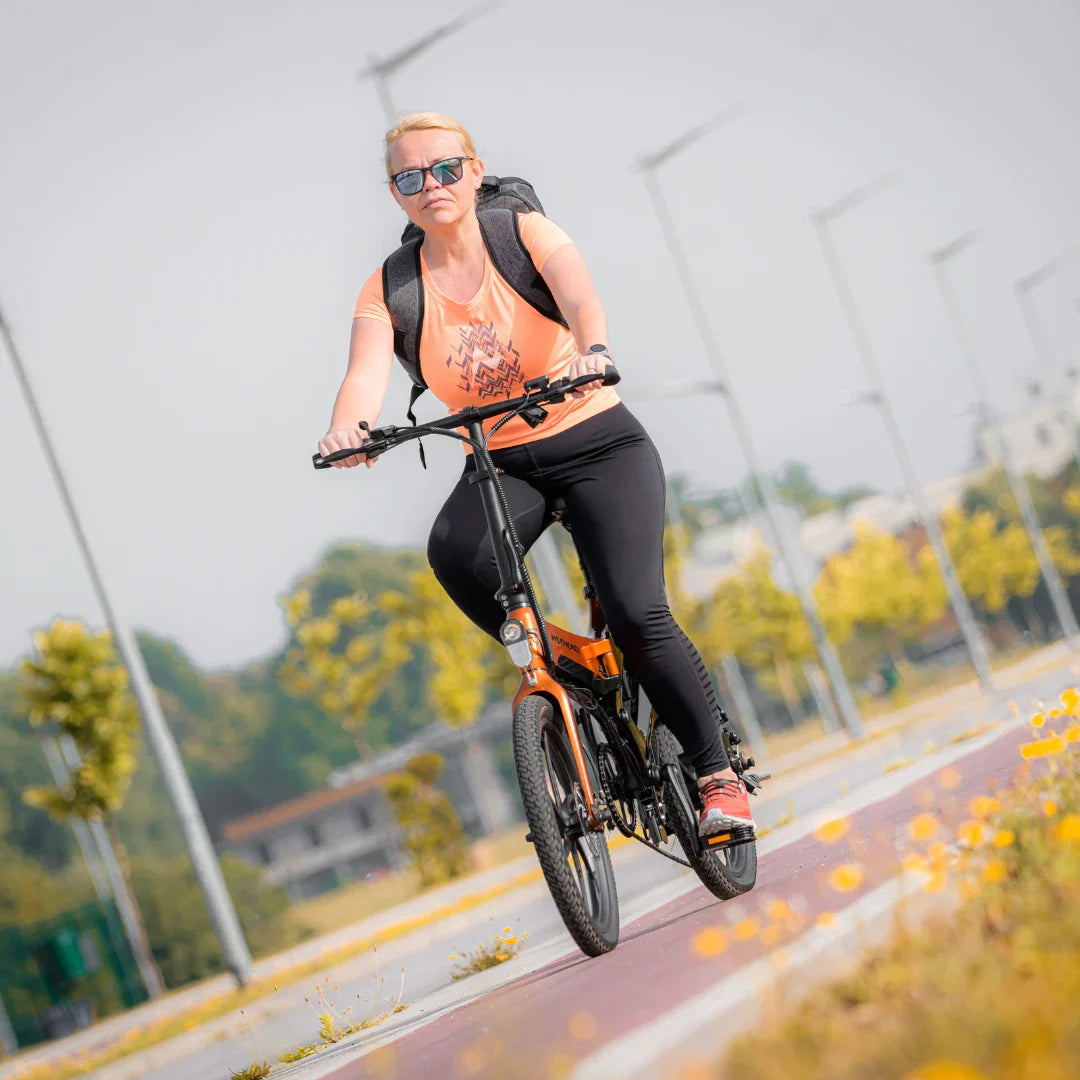 Electric Bike Ms Energy I20, a stylish e-bike in orange, features a sleek design for comfortable rides outdoors.