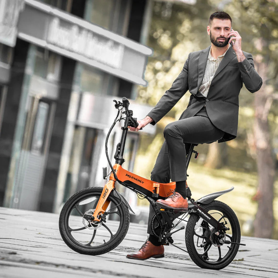 Electric Bike Ms Energy I20 features a sleek design with a vibrant orange frame and compact wheels, ideal for urban commuting.