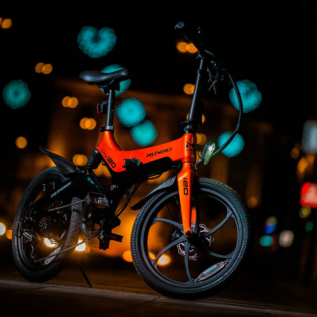 Electric Bike Ms Energy I20 features a vibrant orange frame, compact design, and stylish black wheels.