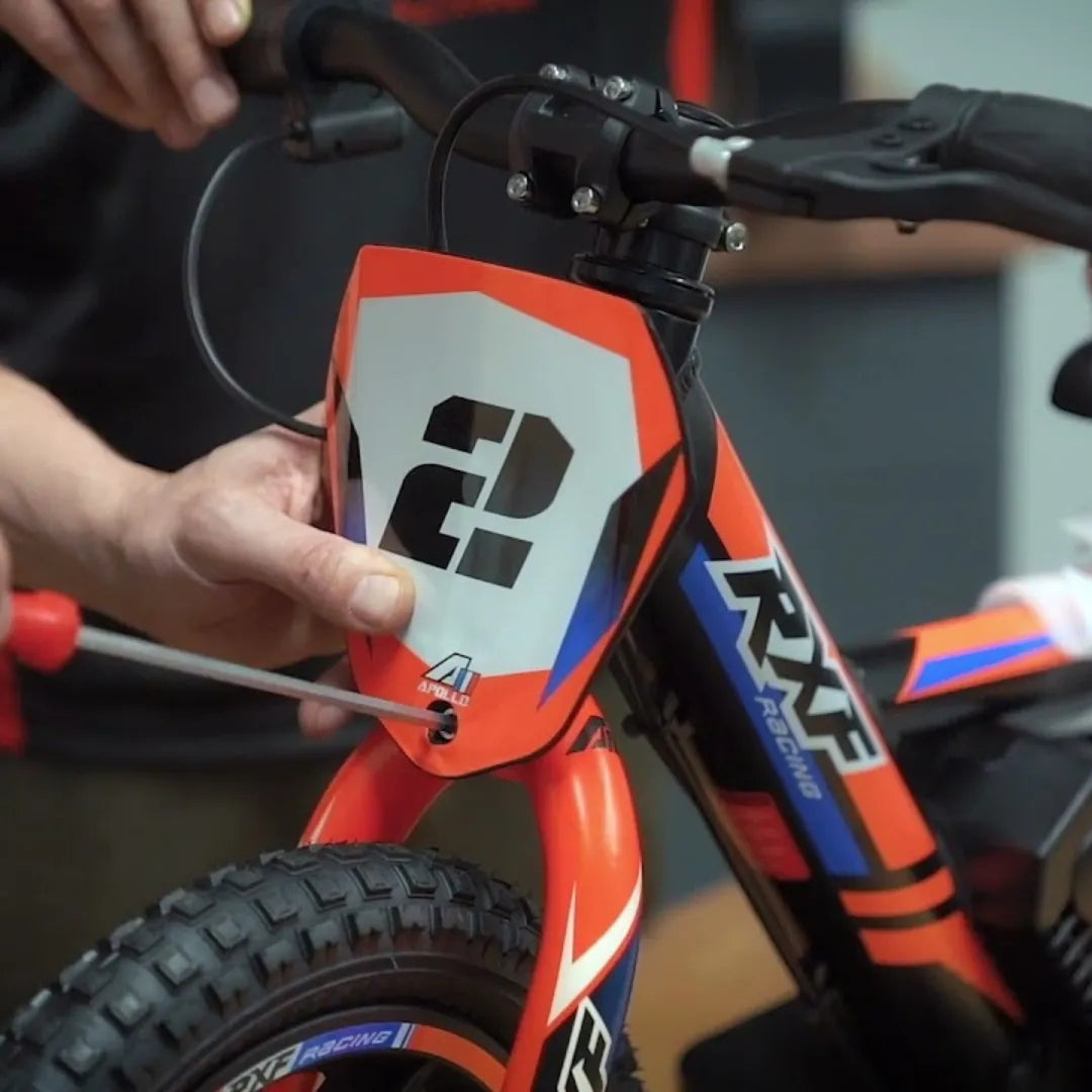 Electric Bike Apollo Sedna 12 Rxf, features a vibrant design, showing assembly of the front fender.