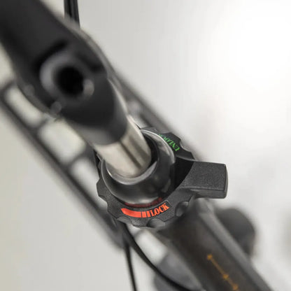 A close-up of the control button on the Cortina Common Family electric bike