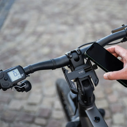 A close-up of the handlebars with phone holder and display on the Cortina E Mozzo electric bike