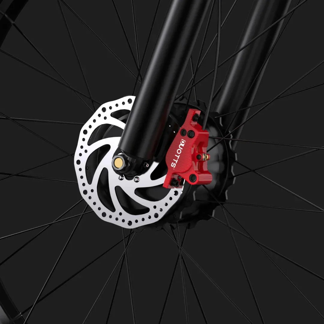 Electric Bike Duotts F26 features a detailed view of its high-performance disc brake system, showcasing a striking red caliper and rotor design for optimal braking efficiency.