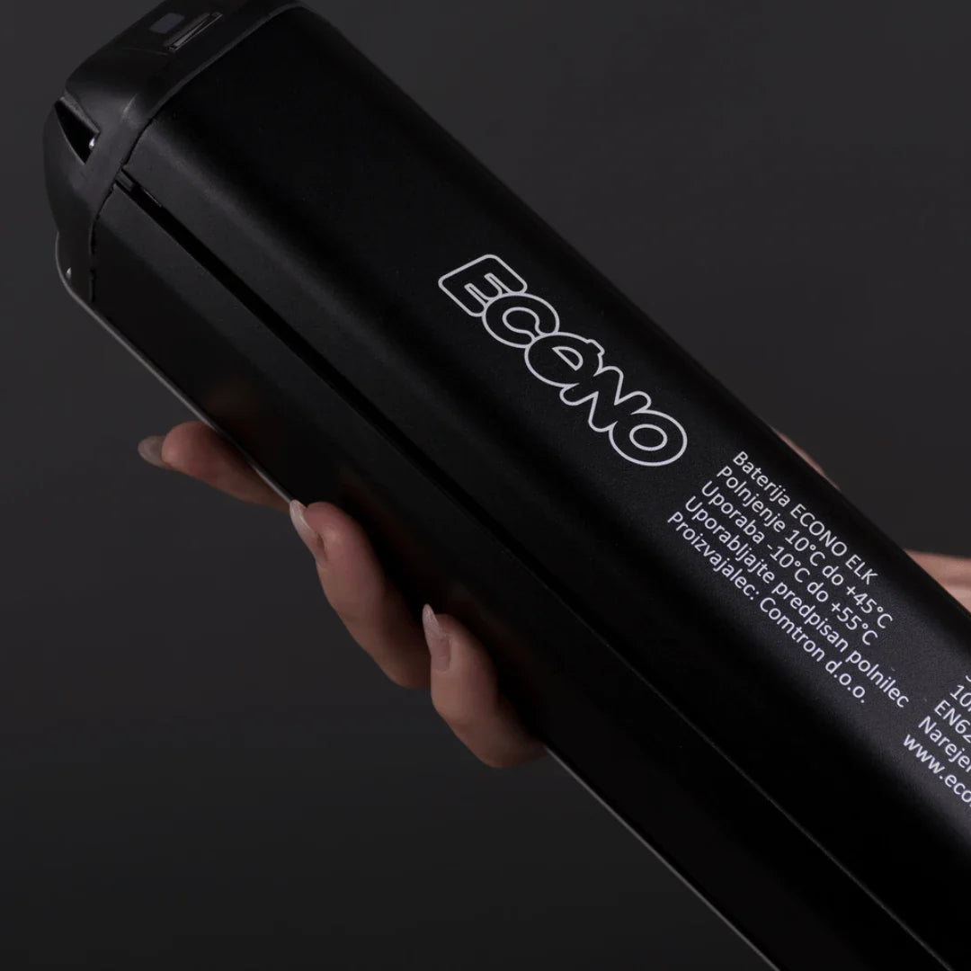 Mountain Electric Bike Econo Pantera C9 160, sleek black battery design, held in a hand, features branding.