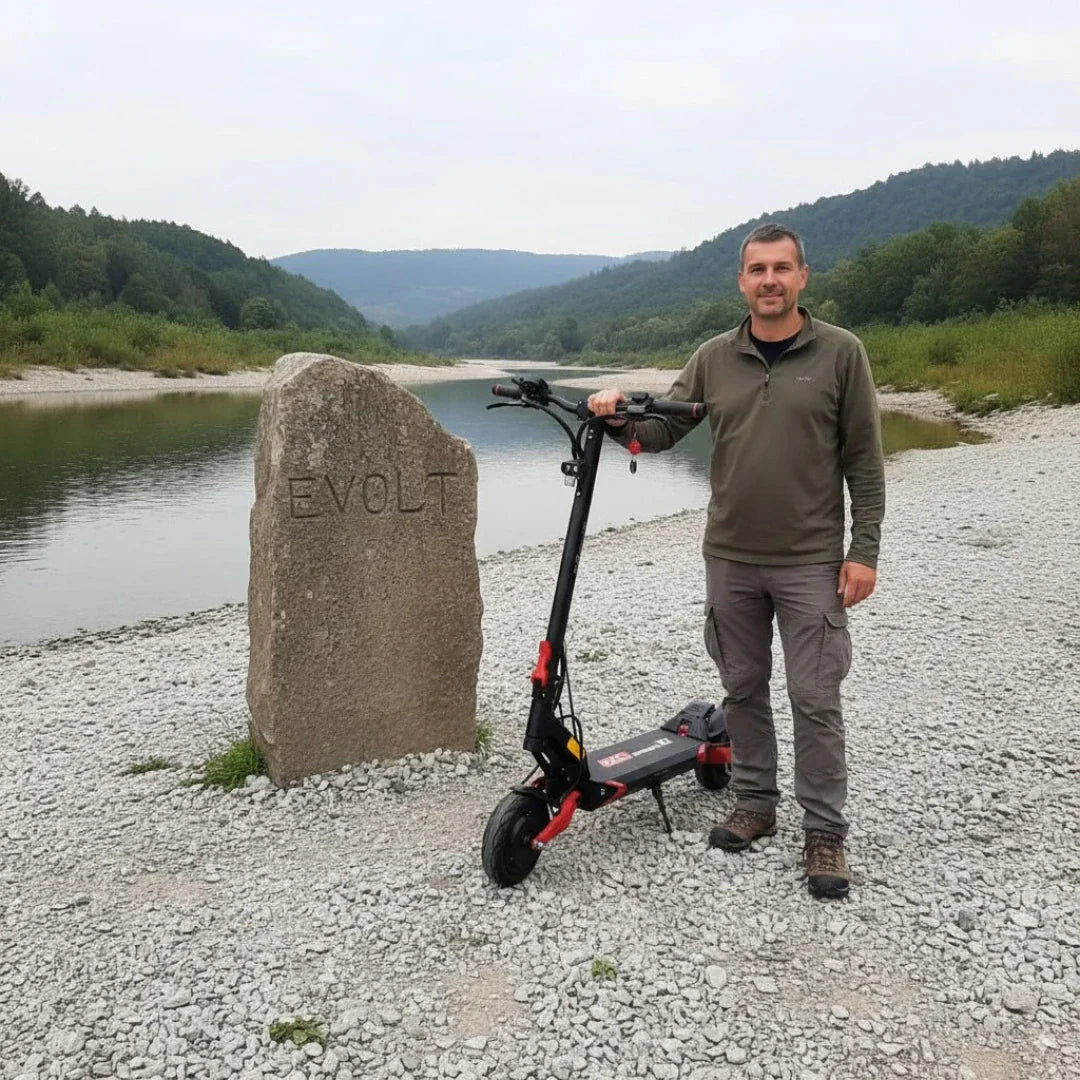 Electric scooter ECO Speed 9X – man standing with scooter by river