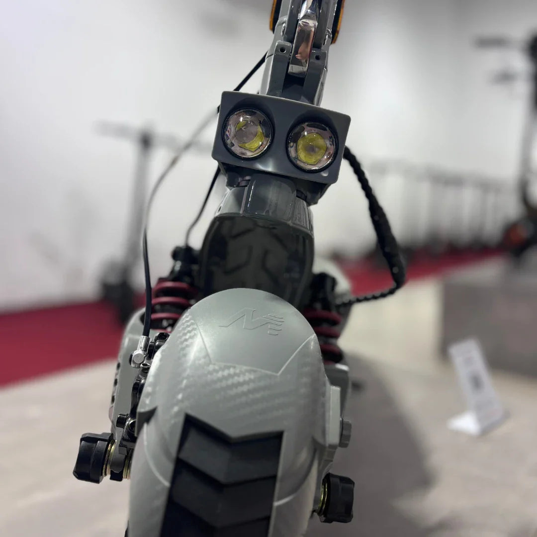 Electric Scooter Eco Speed 10x V2 features dual front lights, a sleek gray design, and robust tires for enhanced grip.