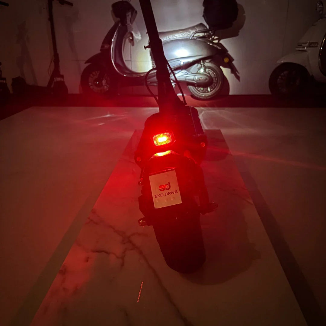 Electric scooter ECO Speed 9X – rear view, red lights illuminated