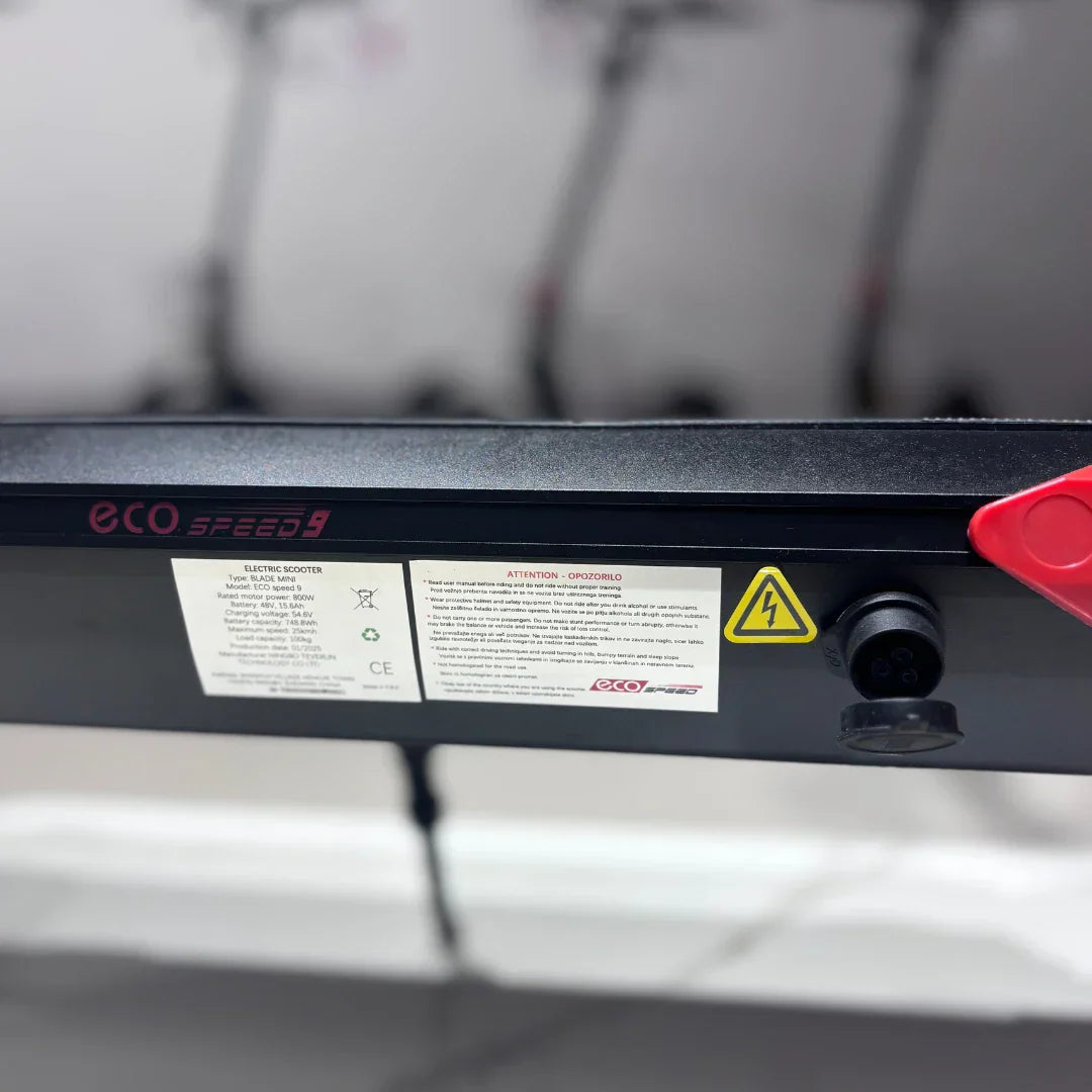 Electric scooter ECO Speed 9 – deck with warning labels and charging port
