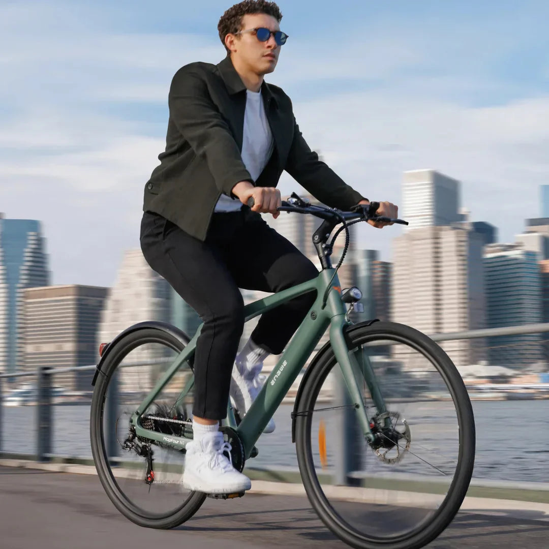 Electric bicycle Engwe MapFour N1 AIR – rider on waterfront path, city background