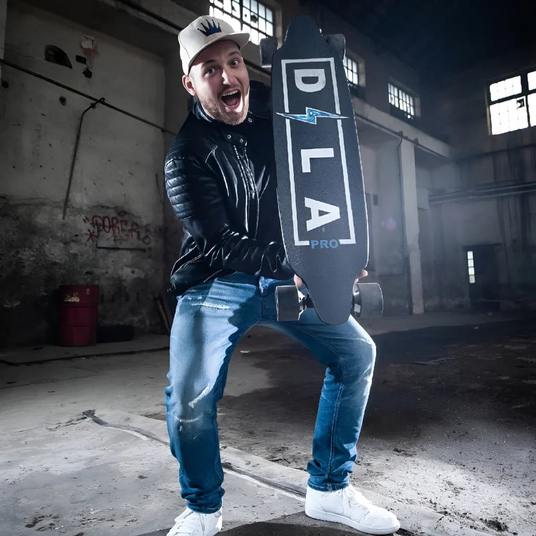 Electric Skateboard Dila Pro features a sleek design, held by an excited individual in an industrial setting.