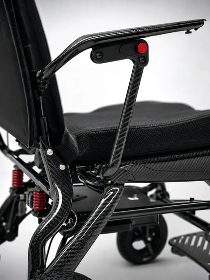 Electric wheelchair ComfyGO IQ-Carbon – close-up of armrest with red button and carbon fiber detail