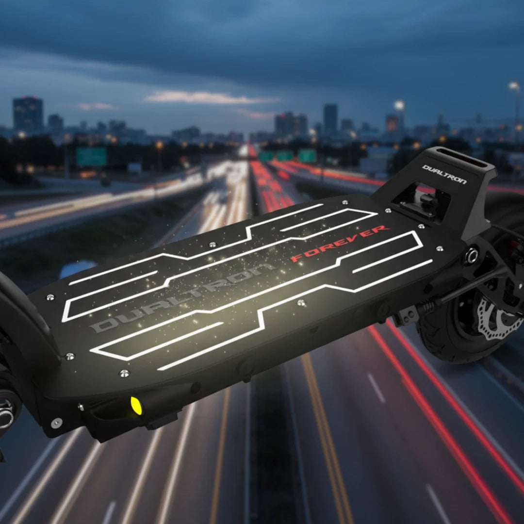 Electric scooter Dualtron Forever – deck with illuminated logo at night