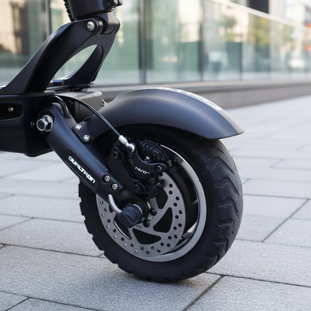 Electric scooter Dualtron Victor Limited – rear wheel, brake, and suspension on pavement