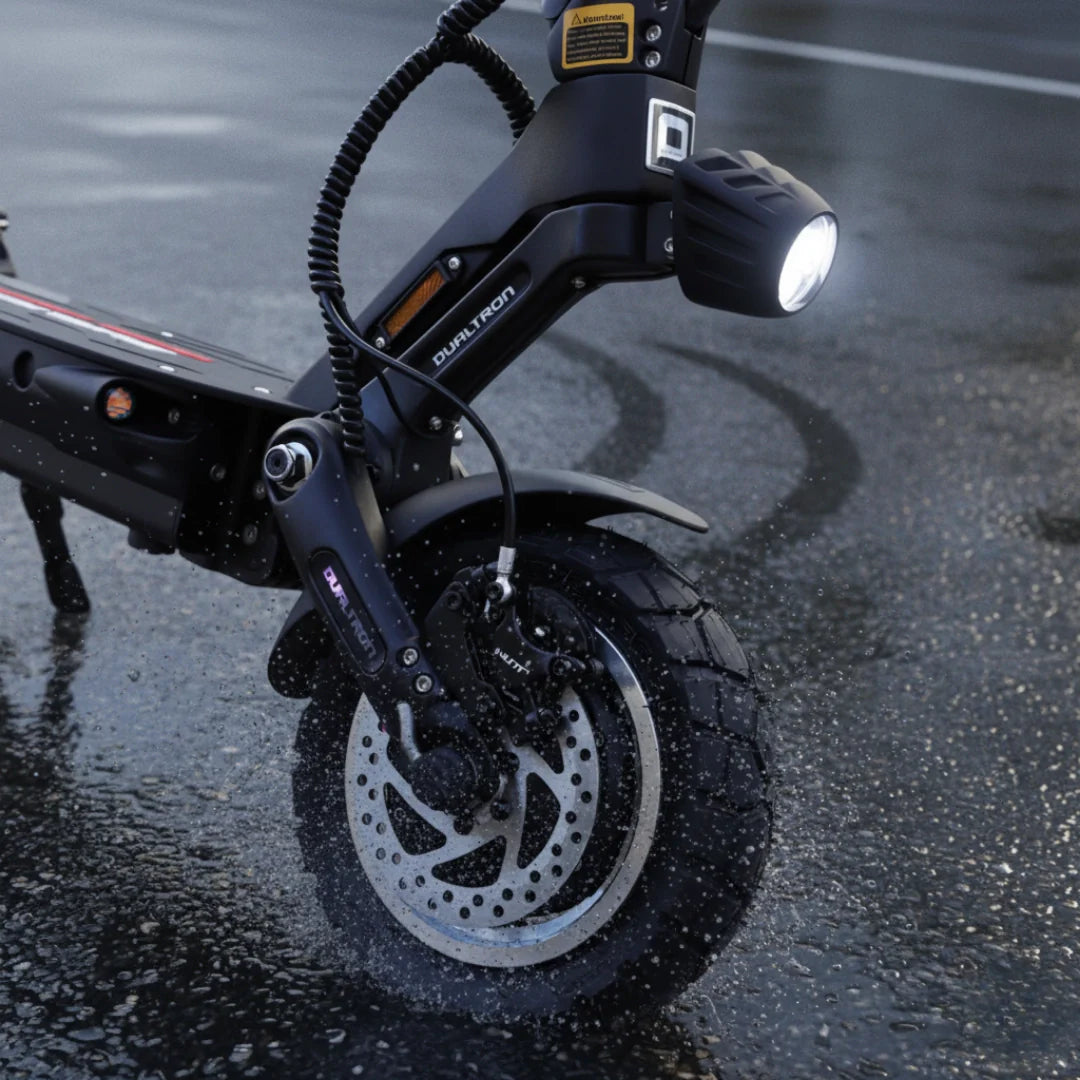 Electric scooter Dualtron Victor Limited – front wheel and headlight on wet ground