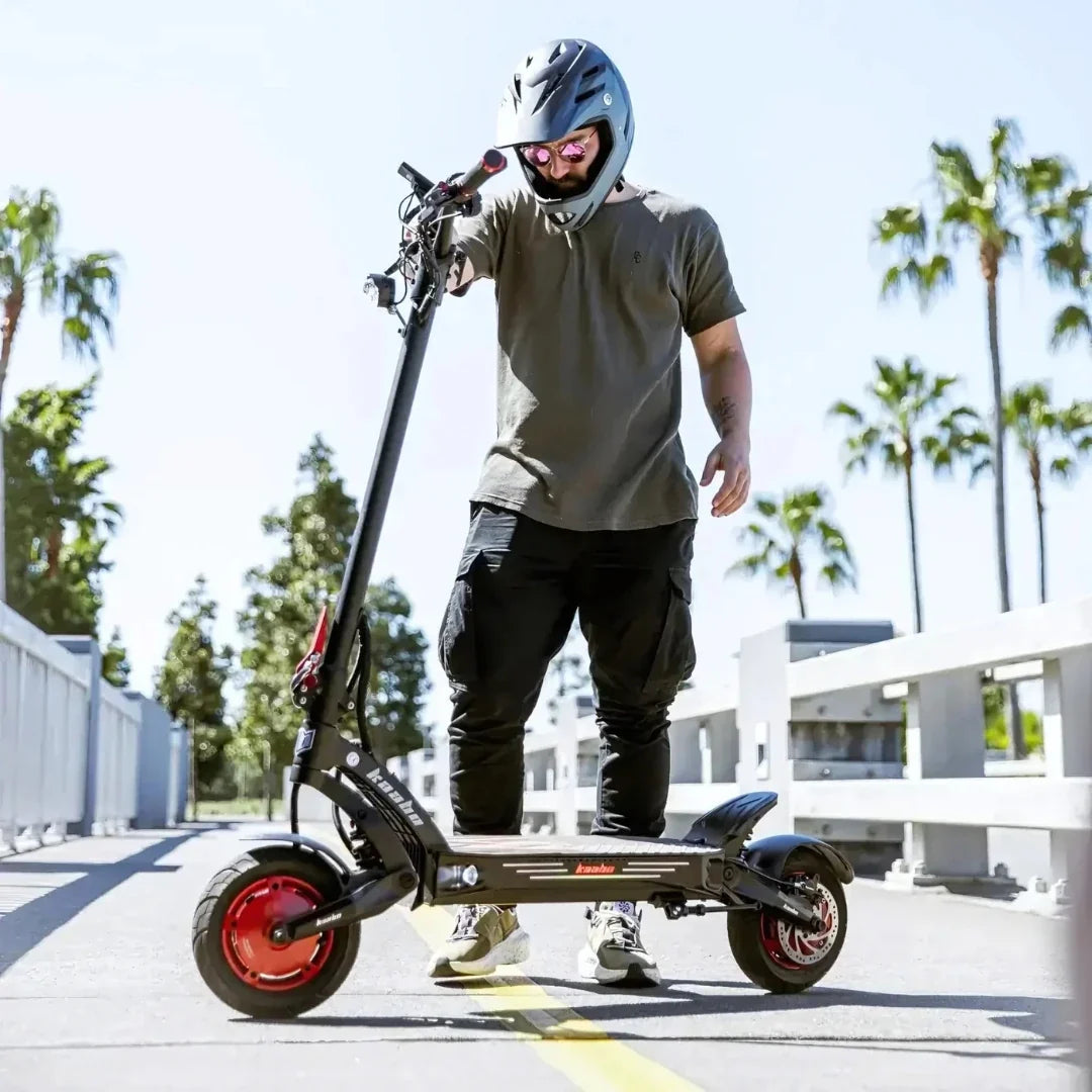 Electric scooter Kaabo Mantis King GT – person standing with scooter, outdoor setting
