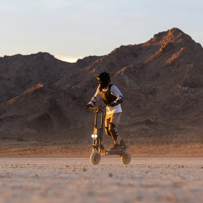 Electric scooter Kaabo Wolf King GTR MAX – rider on desert trail at sunset