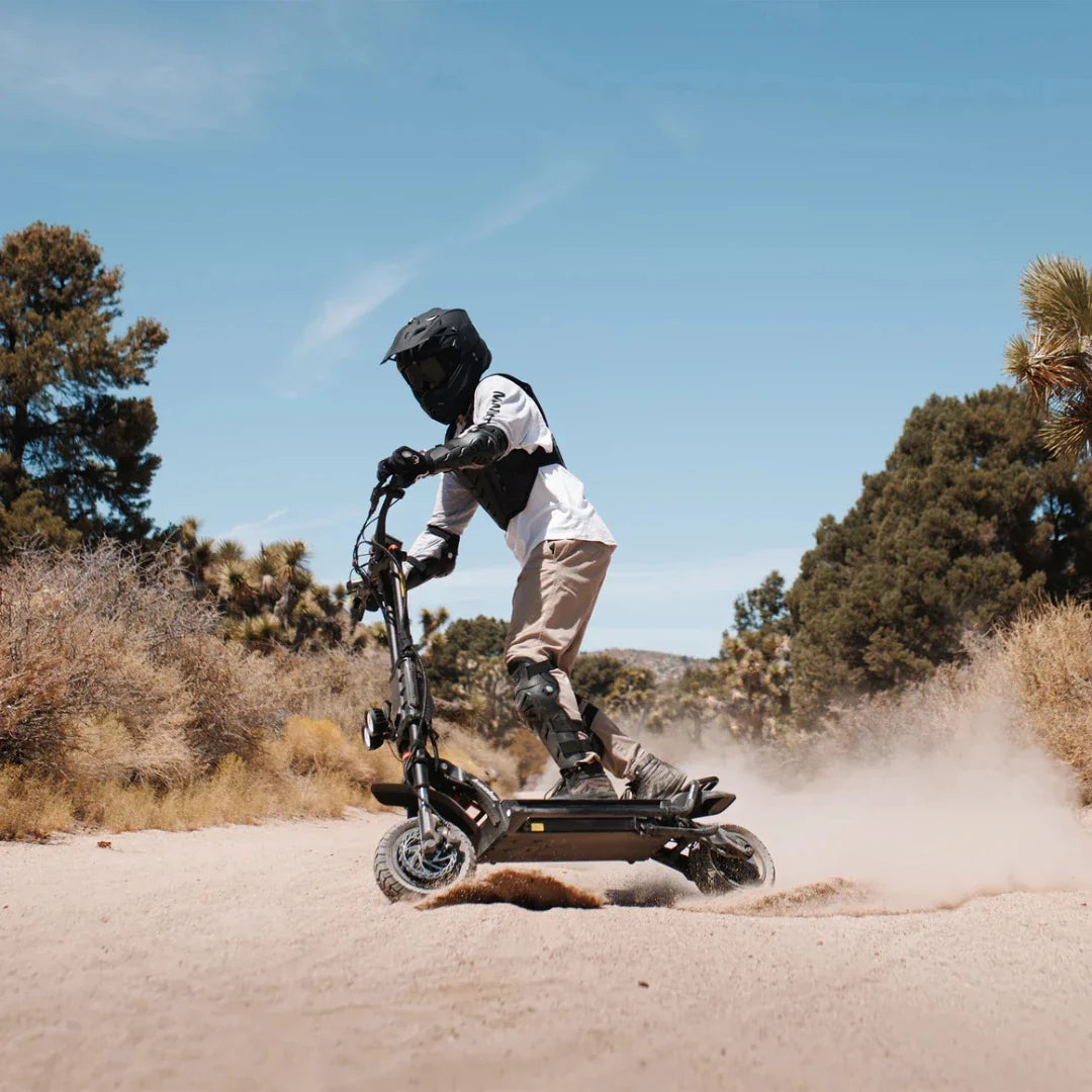 Electric scooter Kaabo Wolf King GTR MAX – rider on dirt track, side view