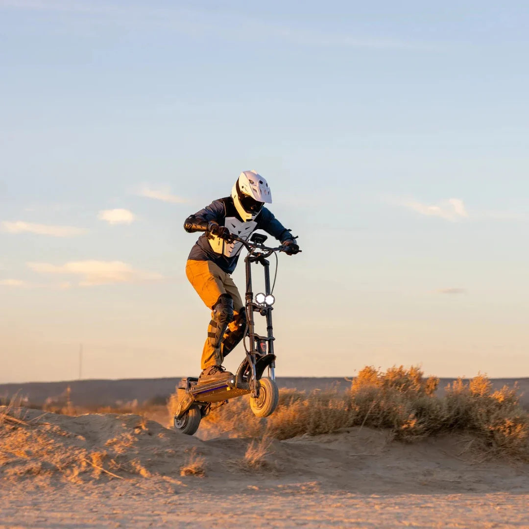 Electric scooter Kaabo Wolf Warrior 11 MAX – rider jumping on dirt track