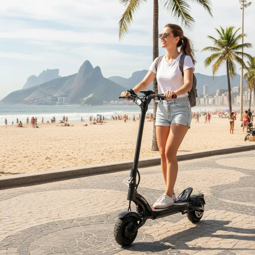 Electric scooter Kaabo Mantis X Plus – woman riding on beach promenade
