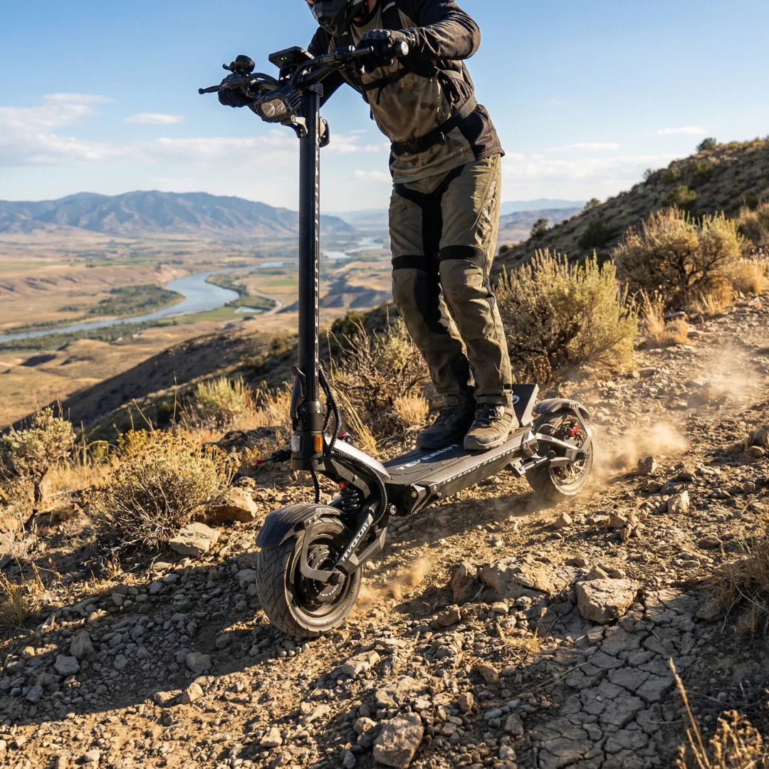 Electric scooter Teverun Fighter 11+ 2026 – rider on dirt path, mountain background