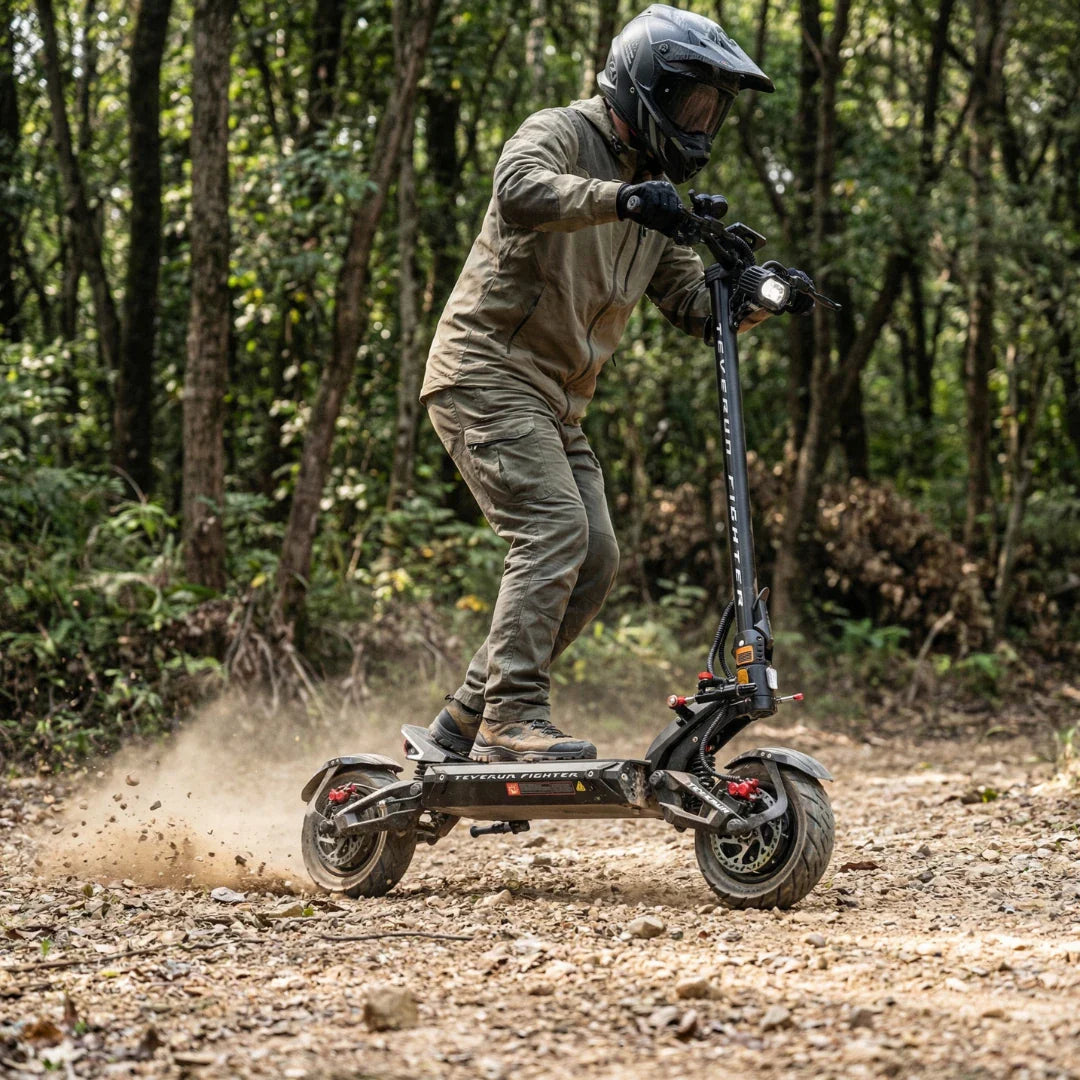 Electric scooter Teverun Fighter 11+ 2026 – rider on forest trail, kicking up dust