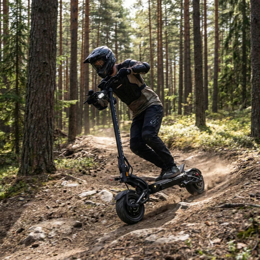 Electric scooter Teverun Fighter 11+ 2026 – rider on forest trail, leaning into turn