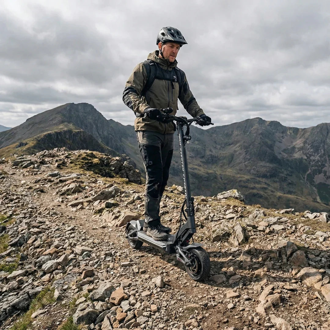 Electric scooter Teverun Fighter Mini PRO 2026 – rider on rocky mountain path