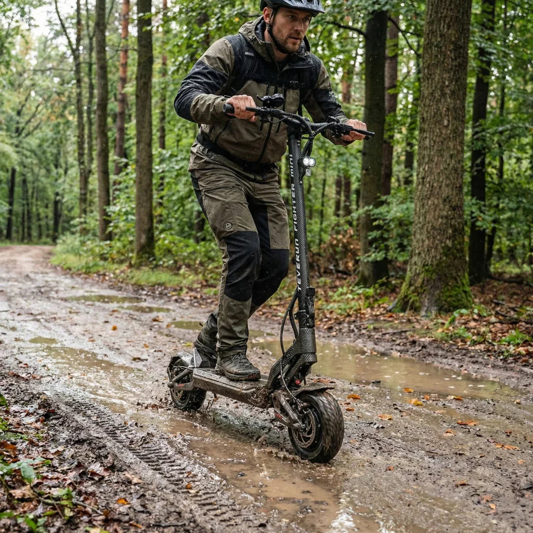Electric scooter Teverun Fighter Mini PRO 2026 – rider in muddy forest