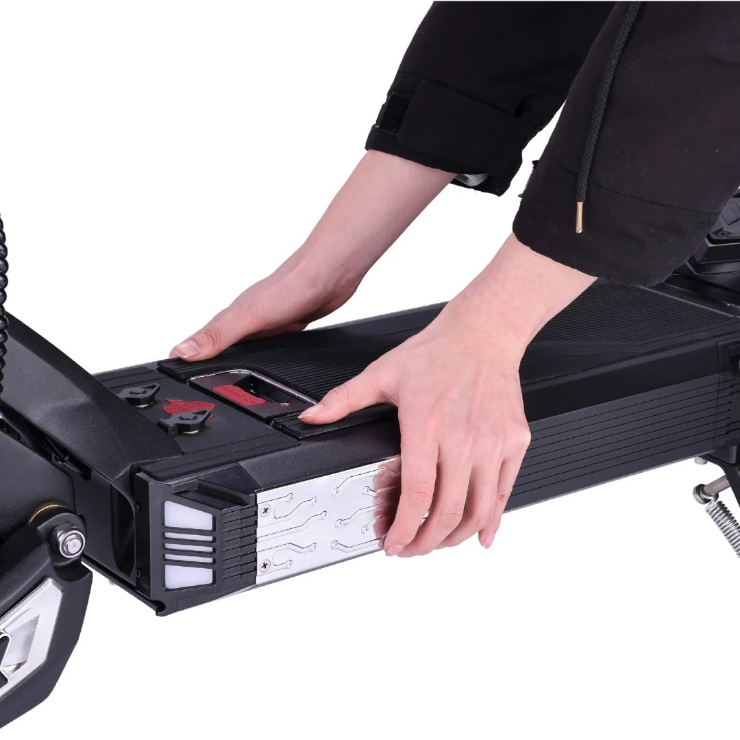 Electric scooter VSETT 10 APEX – hands inserting battery into deck