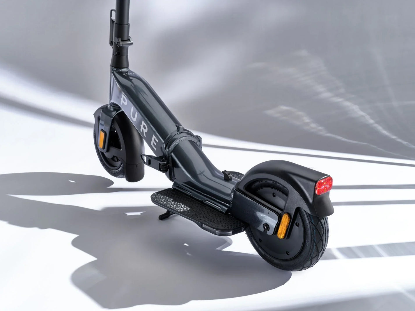Electric scooter Pure FLEX – rear three-quarter view, dark grey colour variant