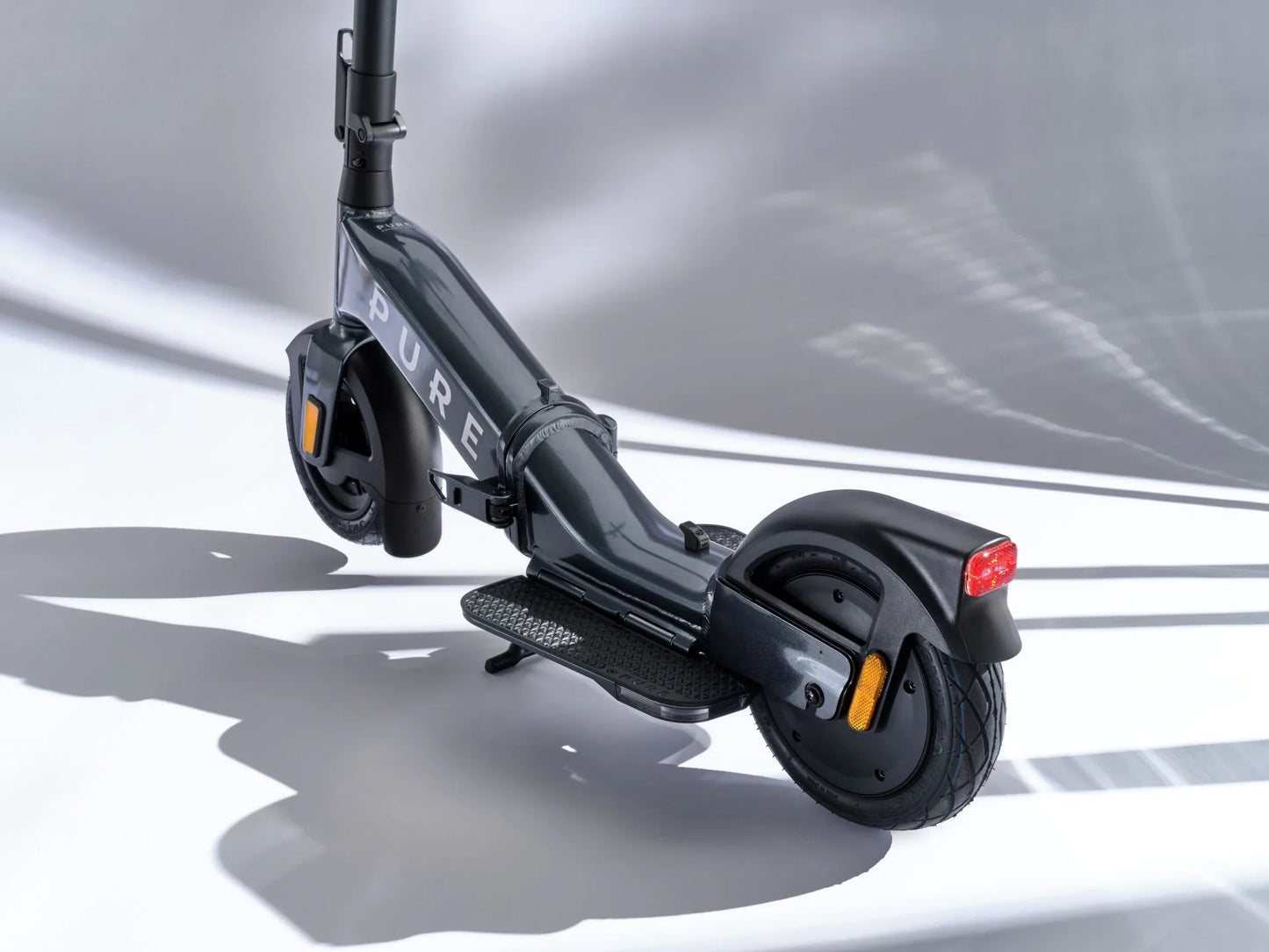 Electric scooter Pure FLEX – rear three-quarter view, dark grey colour variant