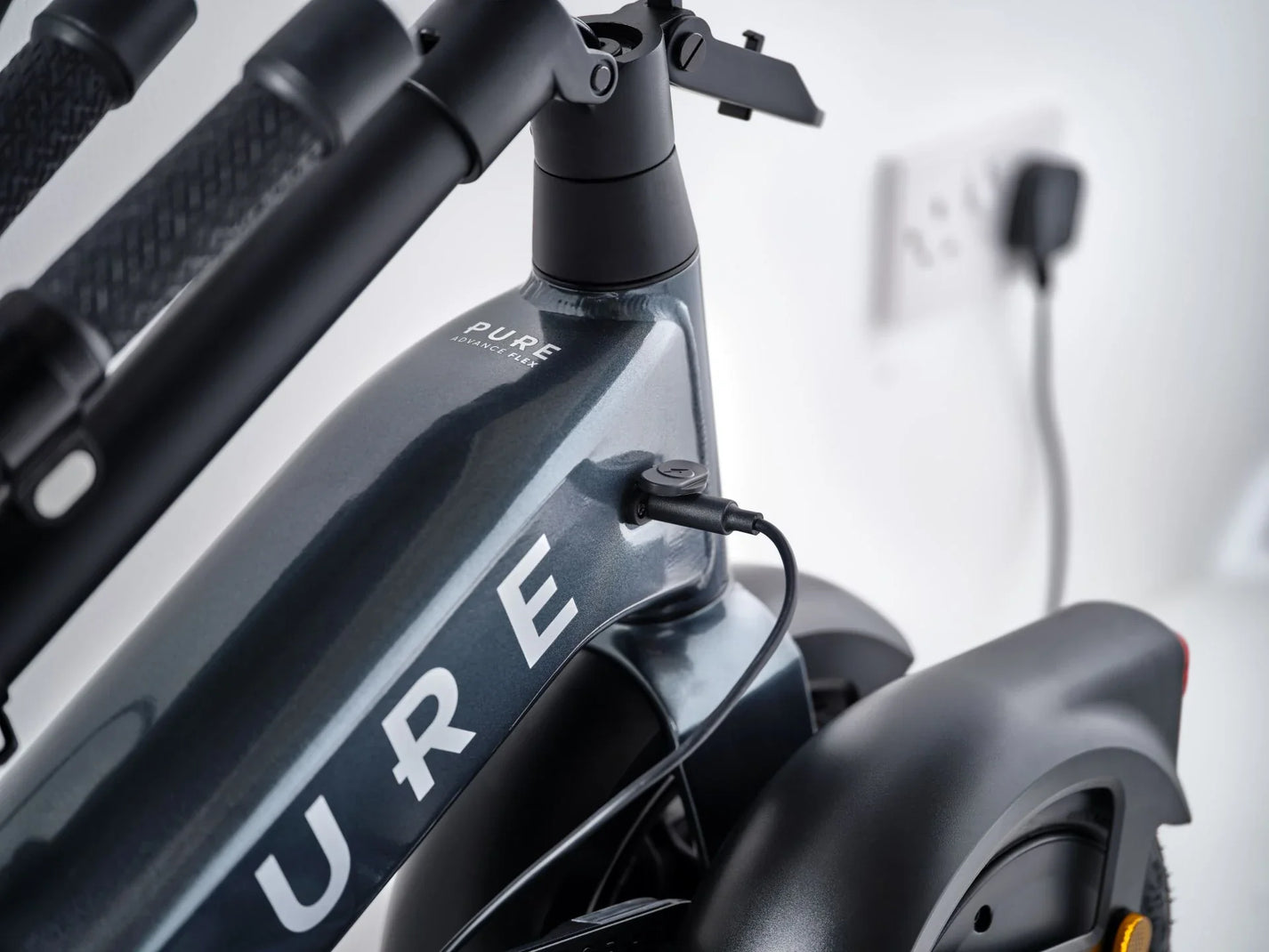Electric scooter Pure FLEX – charging port close-up, grey colour variant