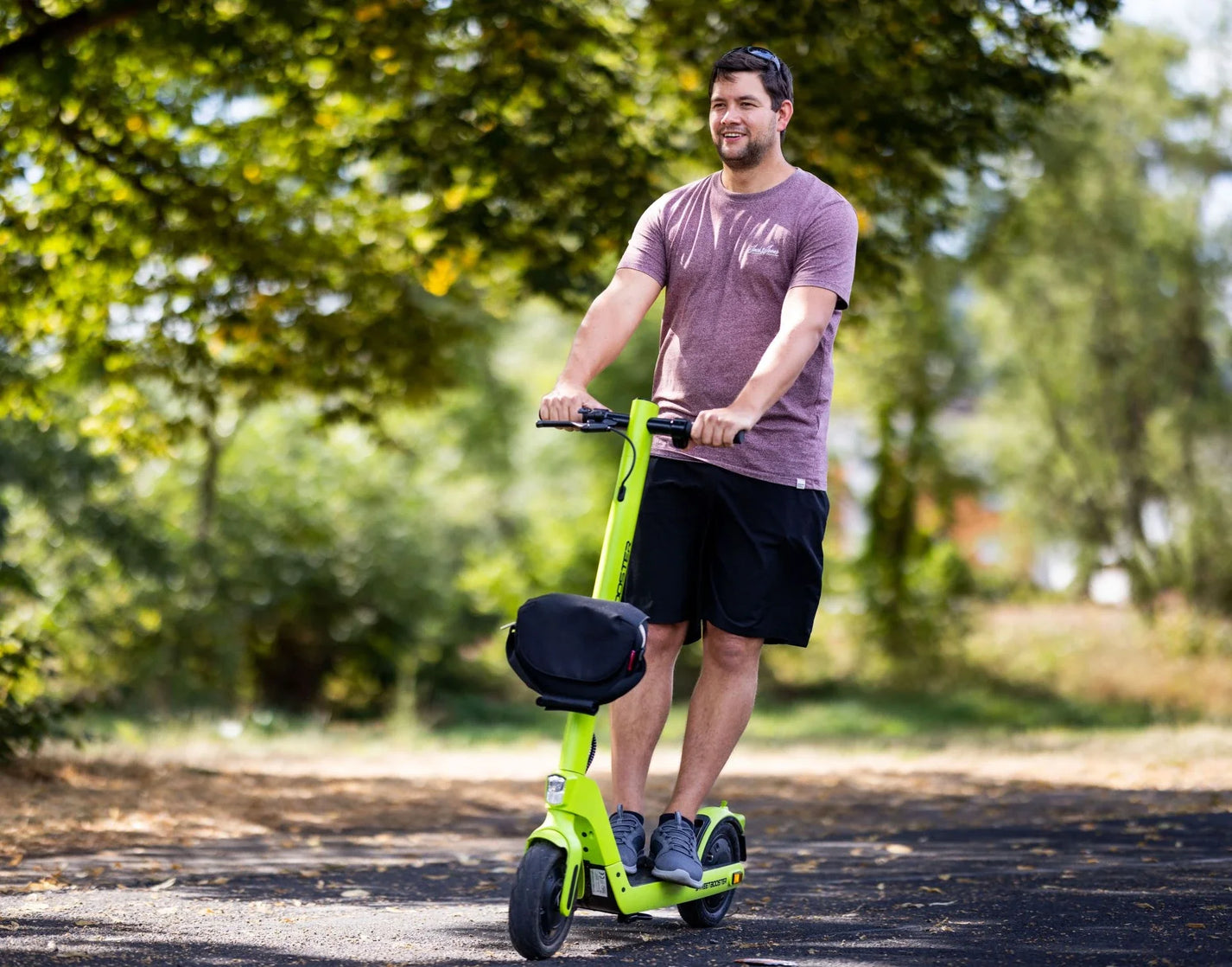 Electric scooter StreetBooster Sirius – man riding with optional seat attachment