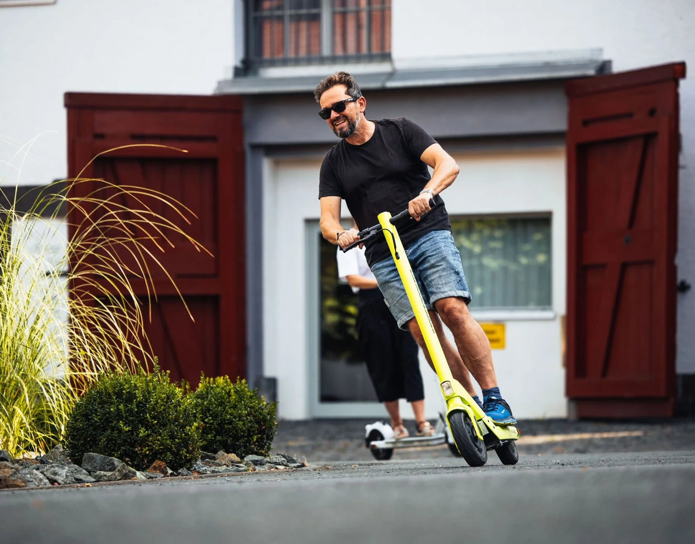 Electric scooter StreetBooster Sirius – man riding on paved driveway