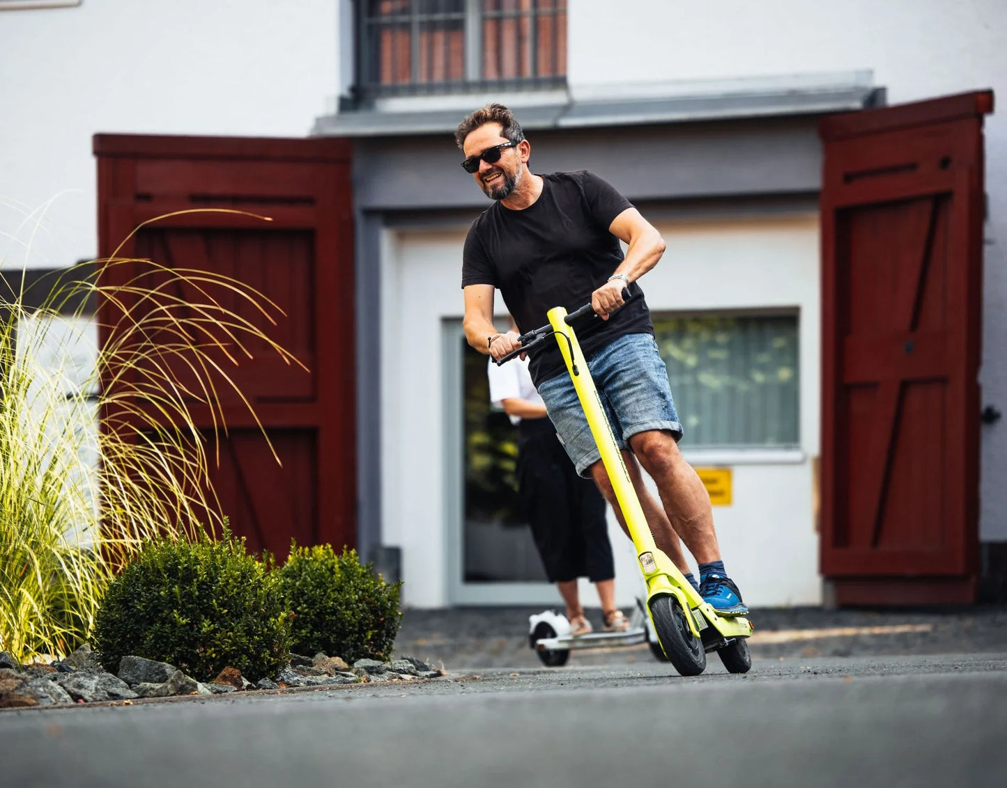 Electric scooter StreetBooster Sirius – man riding on paved driveway