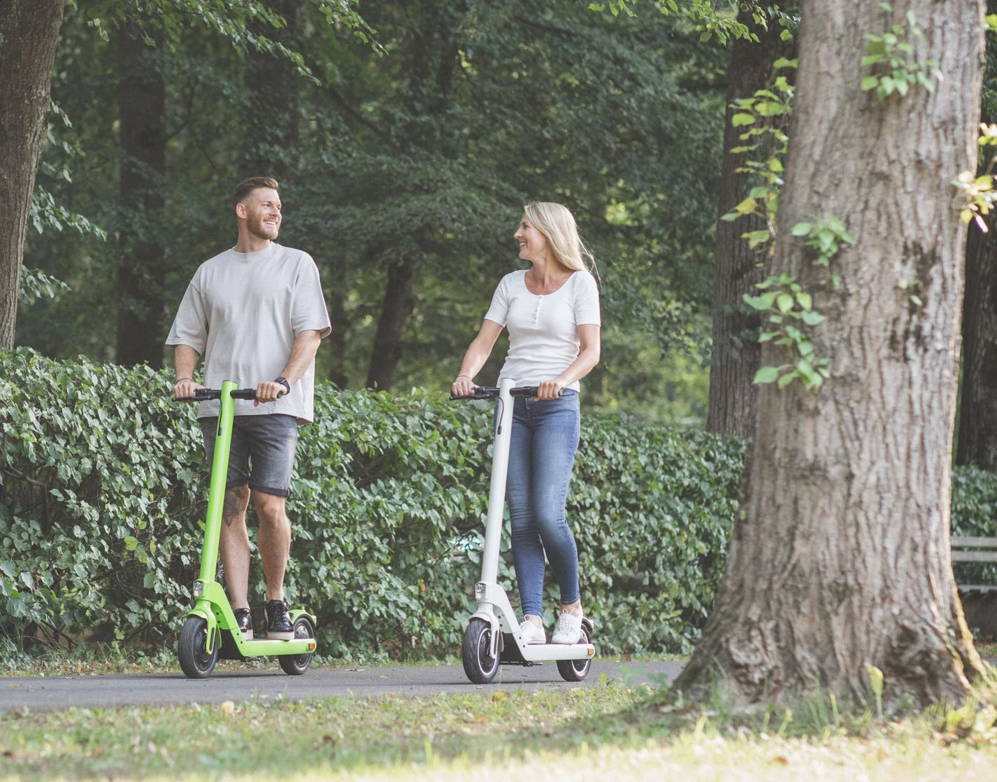 Electric scooter StreetBooster Sirius – man and woman riding in park