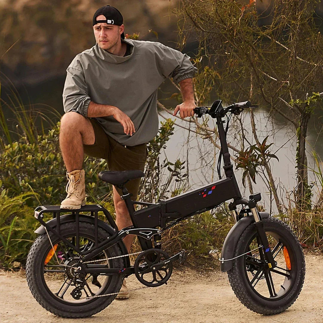 Electric bicycle Engwe Engine X – man standing with bike, foot on pedal