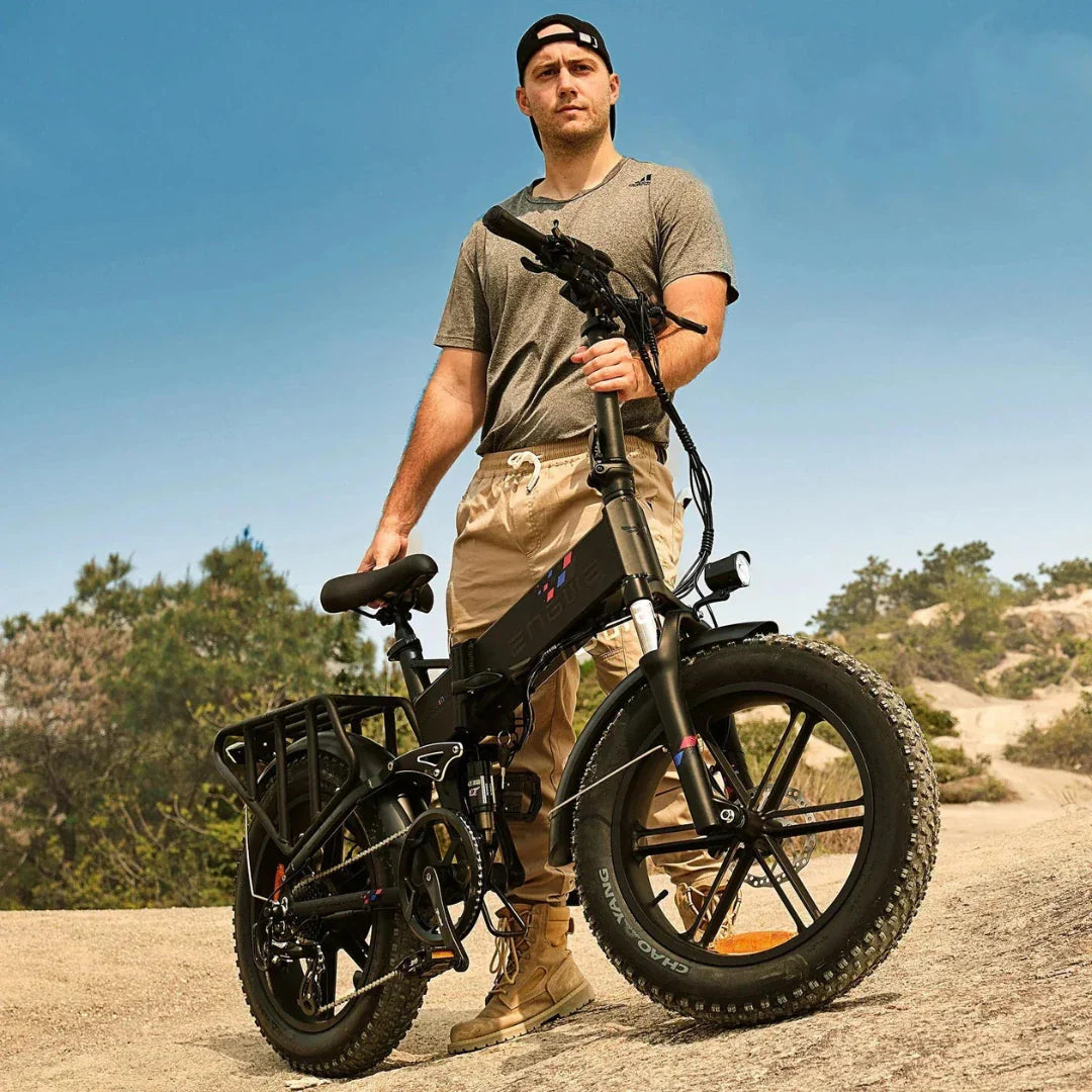 Electric bicycle Engwe Engine X – man standing with folded bike outdoors