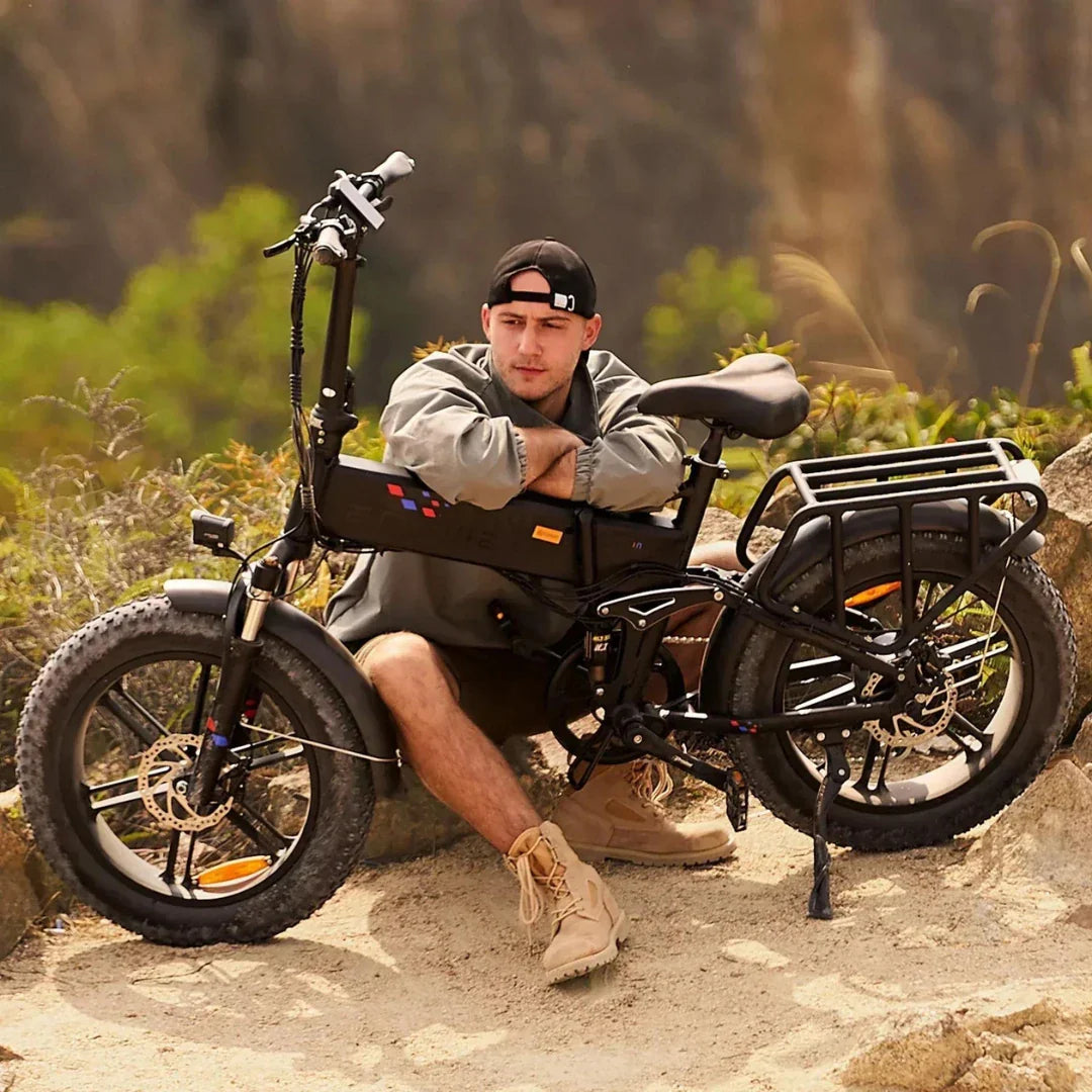 Electric bicycle Engwe Engine X – man resting on folded bike outdoors