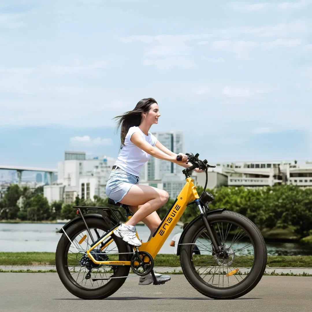 Electric bicycle Engwe E26 – woman riding yellow bike, city background