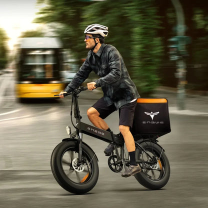 A cyclist rides an electric bike Engwe EP 2 Boost through a city street, showcasing its sleek design and large tires